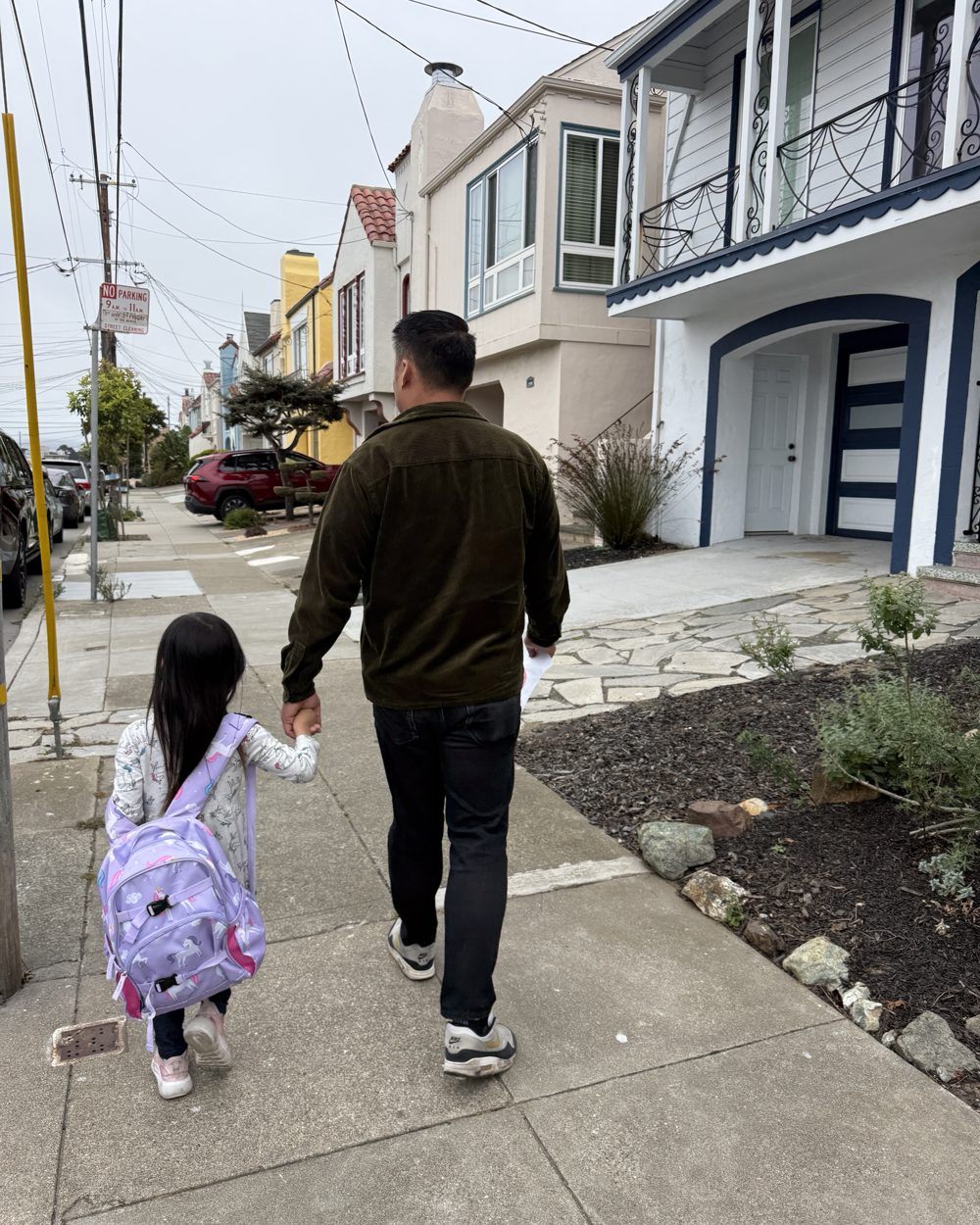 Kevin Choy walking his daughter to school on a Sunset District sidewalk